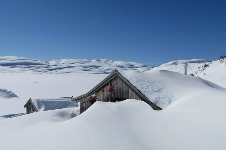 a cabin covered with snow