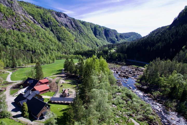 a stream traveling through a lush green hillside