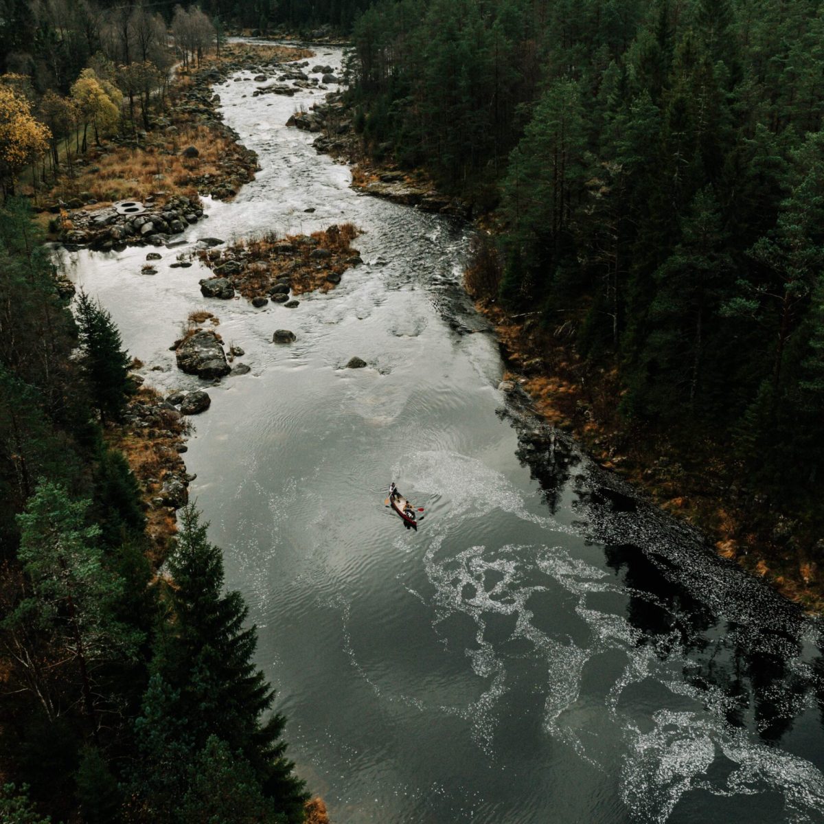 a man riding on top of a river