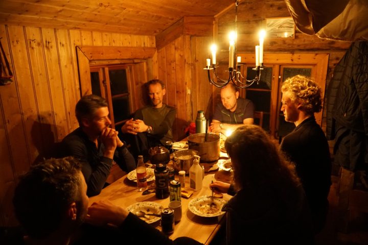 a group of people sitting at a dinner table