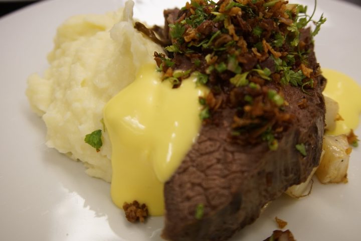 a plate of food with rice meat and vegetables