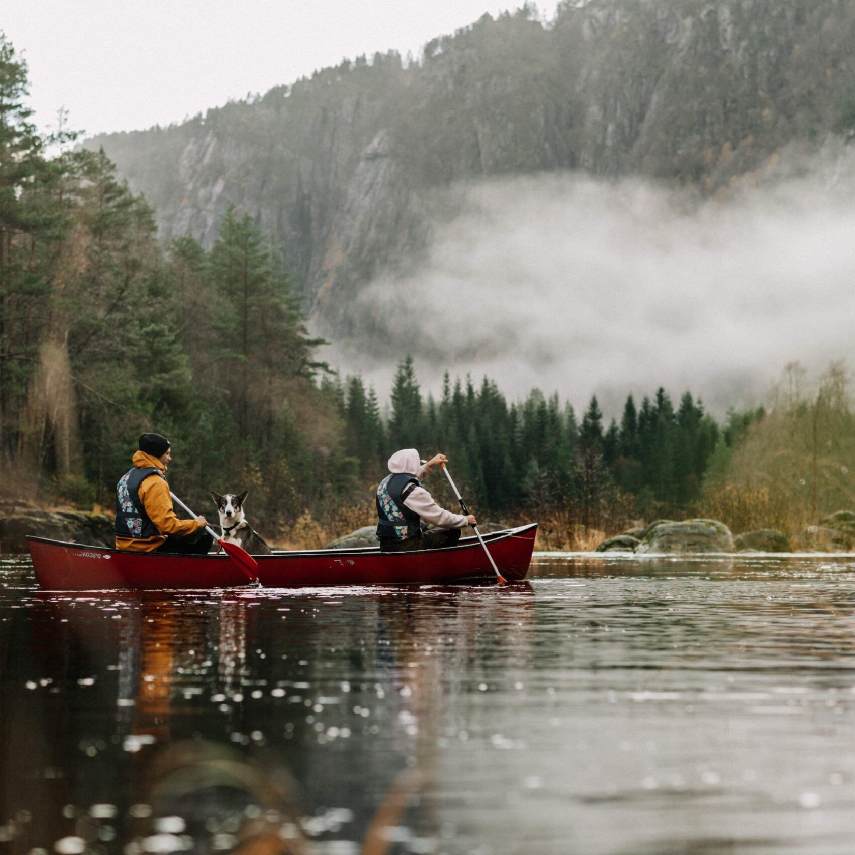 a man riding on the back of a boat in the water