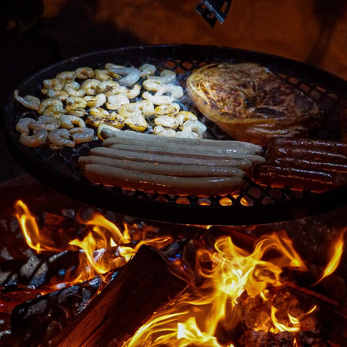 a close up of food being cooked over a fire