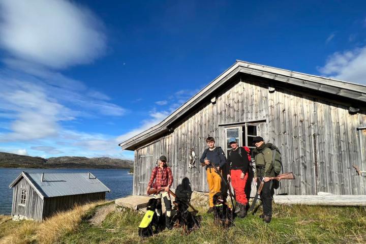 a group of people standing in front of a house