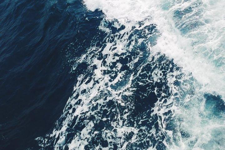 a man riding a wave on top of a body of water